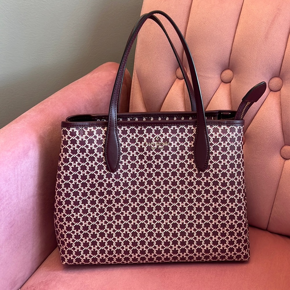 Large maroon purse w/ pink accent.